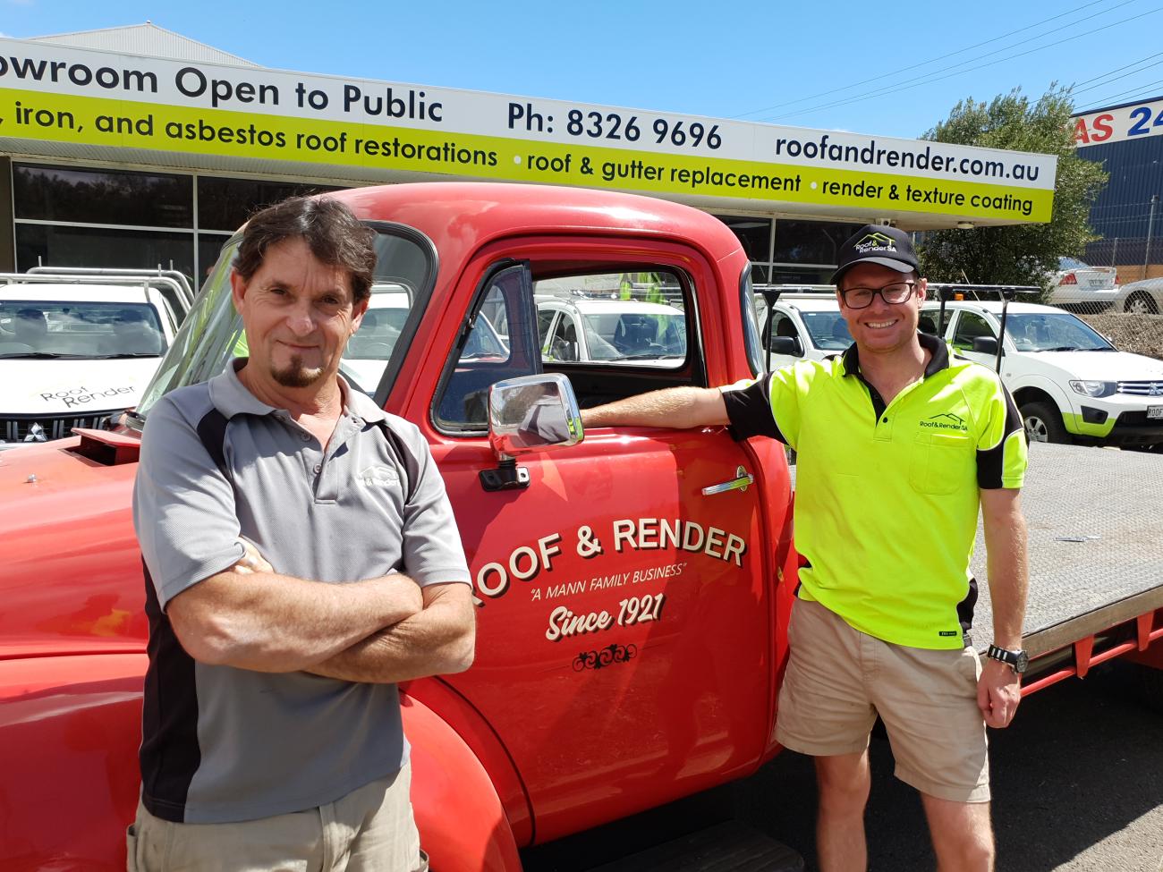 A photo of Ben Mann in front of a bright red classic delivery truck at Roof & Render SA