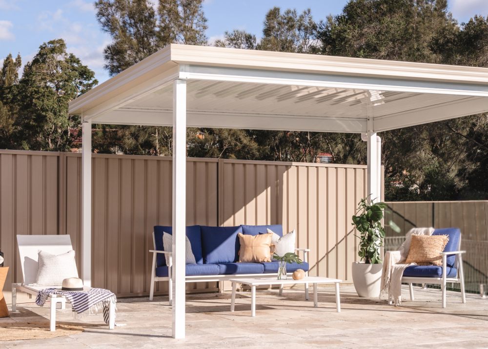 Poolside patio with a light-coloured steel roof, offering shade and style for outdoor entertaining.
