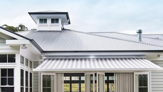 Hamptons style house with Lysaght CUSTOM ORB® roofing and light walls for a classic coastal look.