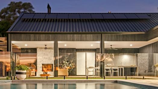 Wide view of a modern home with Lysaght COLORBOND® steel roofing sheets in a dark grey roof colour