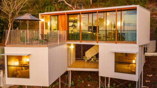 Modern home exterior with wall cladding, showing MINI ORB® cladding used as a subtle feature wall across elevated volumes.