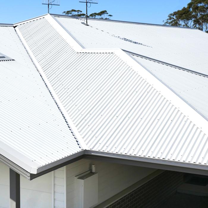 Close-up of metal roof ridges and flashings, illustrating flashing waterproofing at roof intersections.